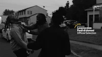 a black and white photo of a group of people in a street