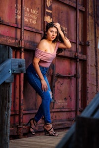 a young woman leaning against a train car