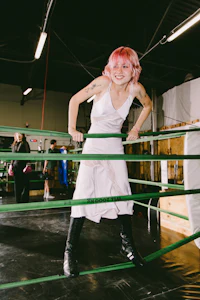 a woman standing in a boxing ring