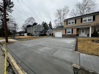 a concrete driveway in front of a house