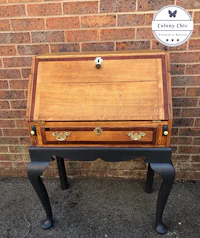 a desk with a wooden top and black legs