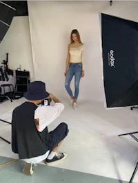 a woman is taking a photo in a photo studio