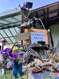 a statue of a bird with flowers on top of it