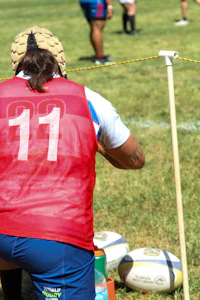 a person bending down to pick up a ball