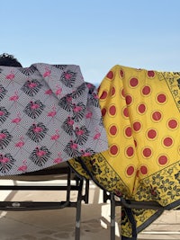 two lounge chairs with two blankets on them