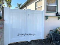 a white gate in front of a house