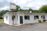 a white building with a sign in front of it